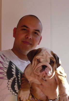 Carlos Granada Holding an English Bulldog Puppy